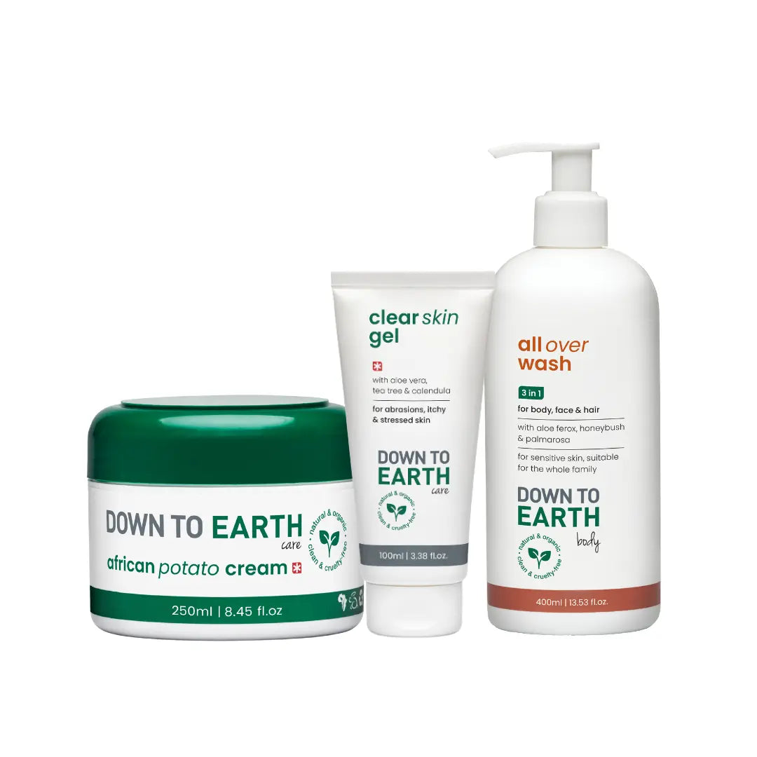 Three Down to Earth body care products on a white background: a green and white jar of African Potato Cream, a white tube of Clear Skin Gel, and a white pump bottle of All Over Wash.