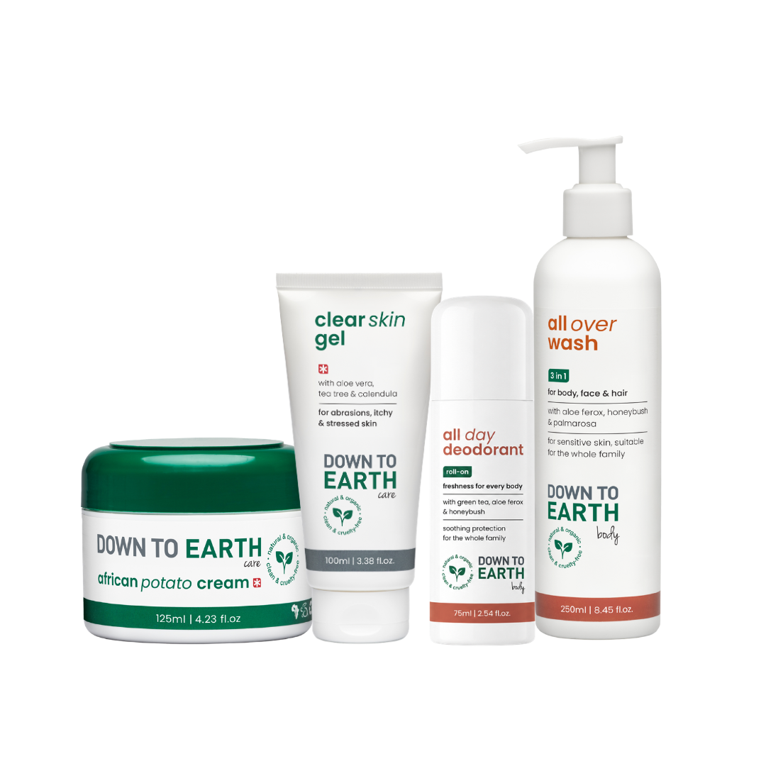 Four Down to Earth body care products arranged together on a white background: a green-and-white jar of african potato cream, a white tube of clear skin gel, a white bottle of all over wash, and a white tube of all day deodorant.